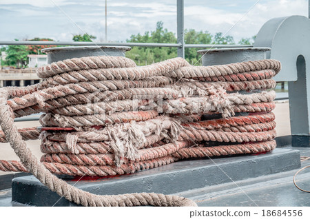 old rope tied with a ship cleat in port old rope tied with a ship cleat in port 18684556