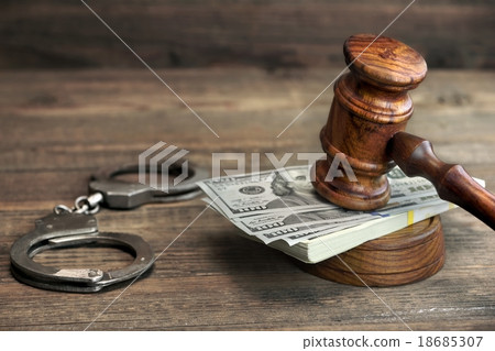 money, handcuffs and judge gavel on wood table 18685307