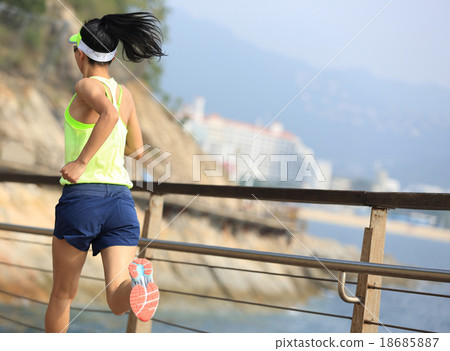 fitness woman running on wooden boardwalk seaside 18685887