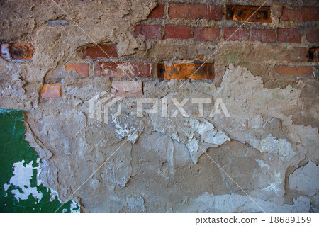 Old brick wall with the damaged plaster 18689159