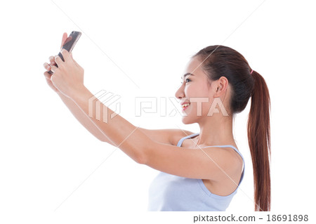 woman taking a selfie using her smartphone woman taking a selfie using her smartphone 18691898