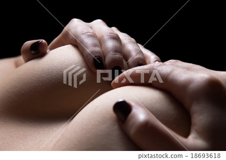Woman's hands holding breasts close up Woman's hands holding breasts close up 18693618