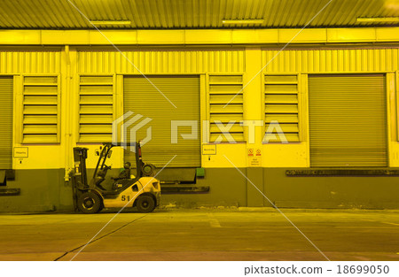 Warehouse with yellow lights at night 18699050