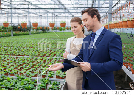 Positive businessman discussing business with his 18702505