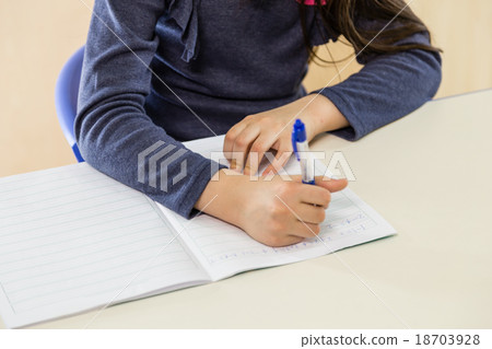 Girl at desk writing Girl at desk writing 18703928