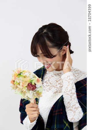 A woman having a young lady hand mirror and relaxing in the room 18704399