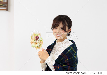 A woman having a young lady hand mirror and relaxing in the room 18704400