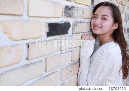 A beautiful, long-haired young lady making a copy space with bricks A beautiful, long-haired young lady making a copy space with bricks 18708913