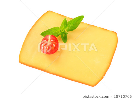 Slice of smoked cheese 18710766