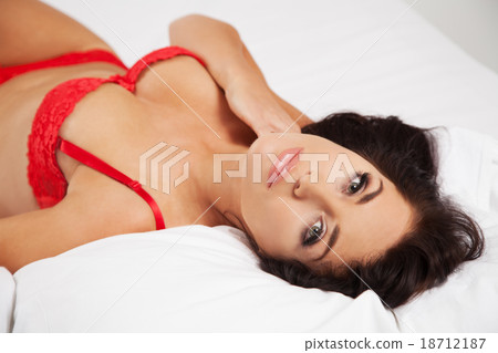Young beautiful woman in her bed 18712187