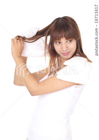 A woman who makes a shampoo and dries it with a towel A woman who makes a shampoo and dries it with a towel 18713817