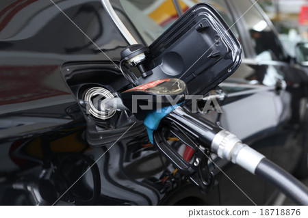 Pumping gasoline fuel in the car at gas station Pumping gasoline fuel in the car at gas station 18718876