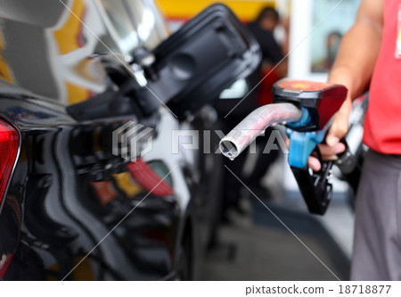 Man holding petrol pump at gas station Man holding petrol pump at gas station 18718877