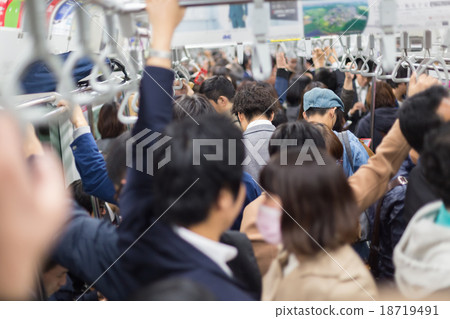 Passengers traveling by Tokyo metro. 18719491
