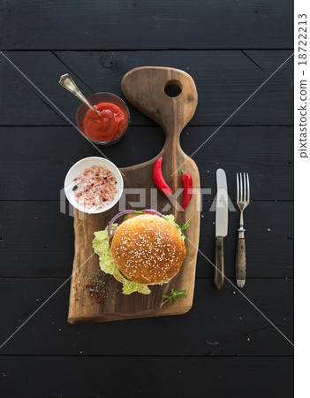 Fresh homemade burger on dark serving board with Fresh homemade burger on dark serving board with 18722213