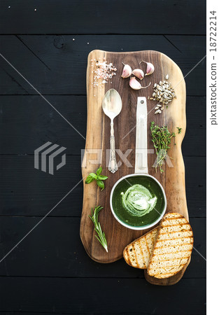 Homemade green spinach cream-soup in a metal scoop Homemade green spinach cream-soup in a metal scoop 18722214