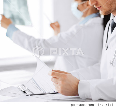 two doctors looking at x-ray two doctors looking at x-ray 18723141