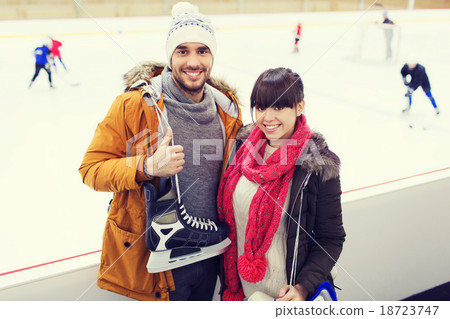 happy couple with ice-skates on skating rink 18723747