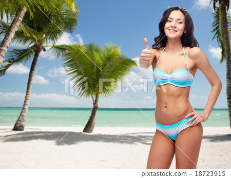 happy woman in swimsuit showing thumbs up happy woman in swimsuit showing thumbs up 18723915