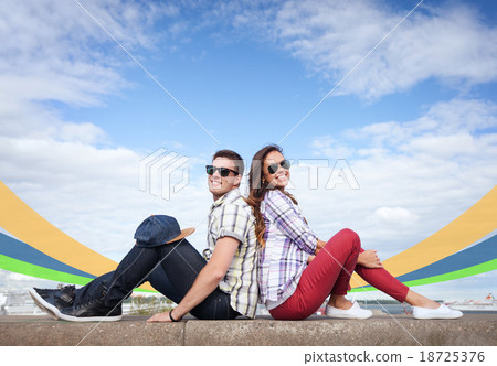 teenagers sitting back to back 18725376