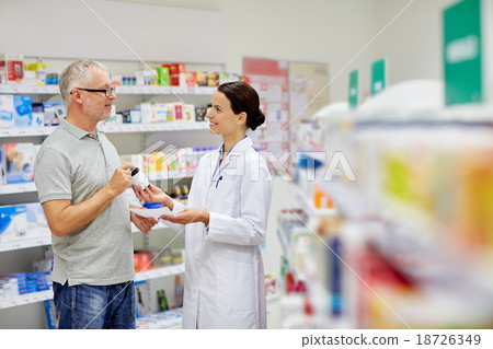 pharmacist and senior man buying drug at pharmacy pharmacist and senior man buying drug at pharmacy 18726349
