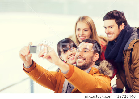 happy friends with camera on skating rink happy friends with camera on skating rink 18726446