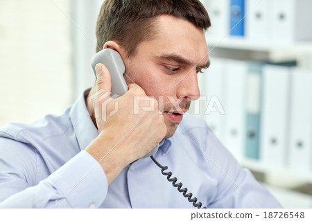 face of businessman calling on phone in office face of businessman calling on phone in office 18726548