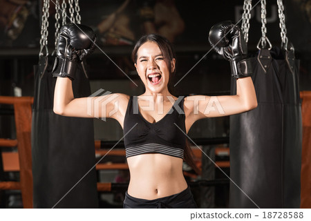 Cheerful woman boxer celebrating victory Cheerful woman boxer celebrating victory 18728588