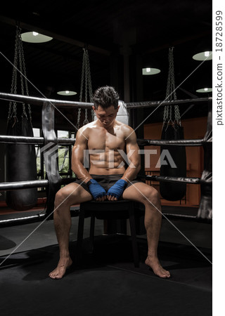young boxer sitting on his corner of the ring 18728599
