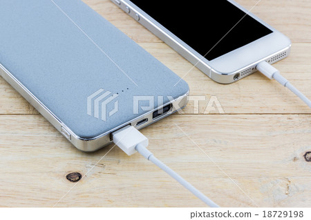Smartphone with grey powerbank. 18729198