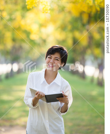 portrait of young woman and book in hand portrait of young woman and book in hand 18730090