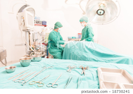 Stock Photo: Surgical tools and a surgical team is working