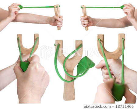 set of hands with simple wooden slingshot 18731466