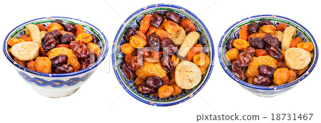 set of traditional ceramic bowls with dried fruits 18731467