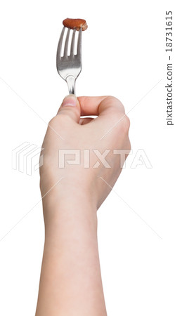 hand holds dinning fork with impaled one brown bob 18731615