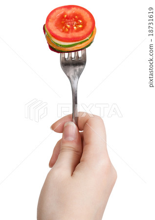 fork with impaled fresh sliced vegetables in hand 18731619