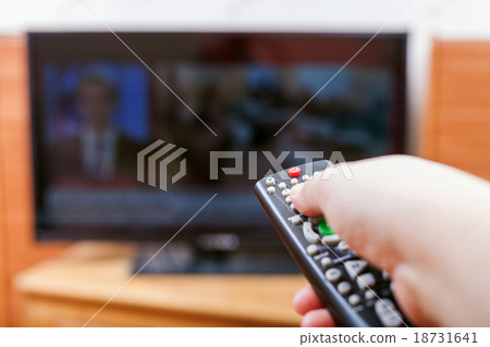 Hand switches TV channels with news 18731641