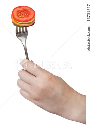 fresh sliced vegetables impaled on fork in hand 18731837