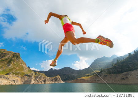 Skipping girl as he runs near a mountain lake Skipping girl as he runs near a mountain lake 18731893