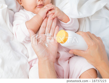 Mother preparing baby powder bottle in her hand Mother preparing baby powder bottle in her hand 18737223