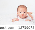 Asian baby lying on stomach. looking 18739072