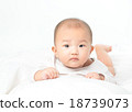 Asian baby lying on stomach. looking 18739073