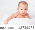 Asian baby lying on stomach. looking 18739075