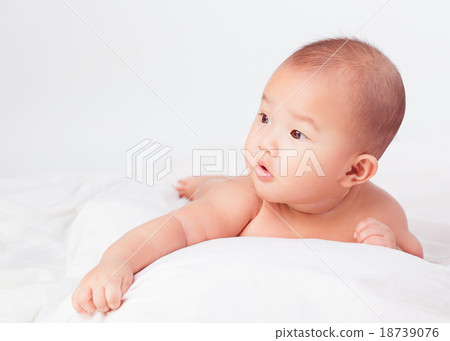 Asian baby lying on stomach. looking 18739076