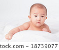 lovely Asian baby lying on stomach. looking 18739077