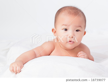 lovely Asian baby lying on stomach. looking 18739077