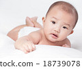 cute Asian baby lying on stomach. looking 18739078