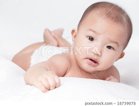 cute Asian baby lying on stomach. looking 18739078