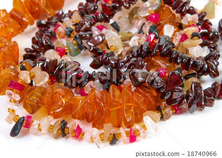 beads of different stones on a white background 18740966