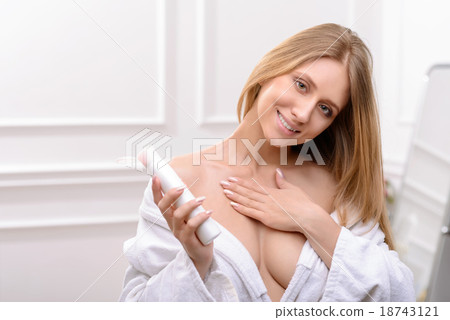 Pleasant woman using cream for body Pleasant woman using cream for body 18743121